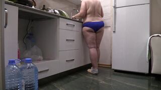 big beautiful woman mother I'd like to fuck housewife in the kitchen wearing merely pants. - 1 image