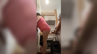 in the kitchen half-dressed