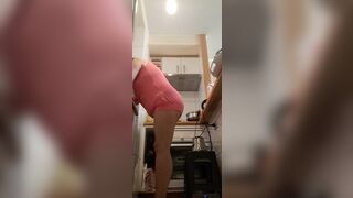 in the kitchen half-dressed